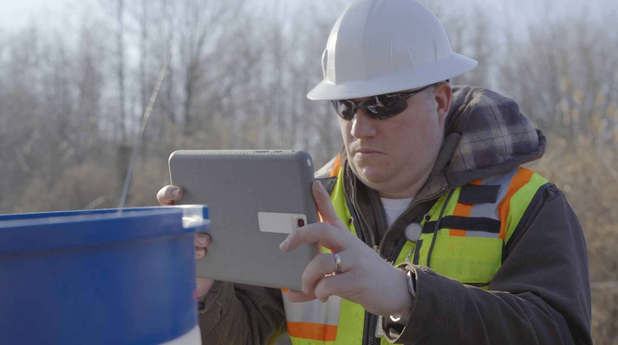 Inspection worker scanning barrel with mobile app.